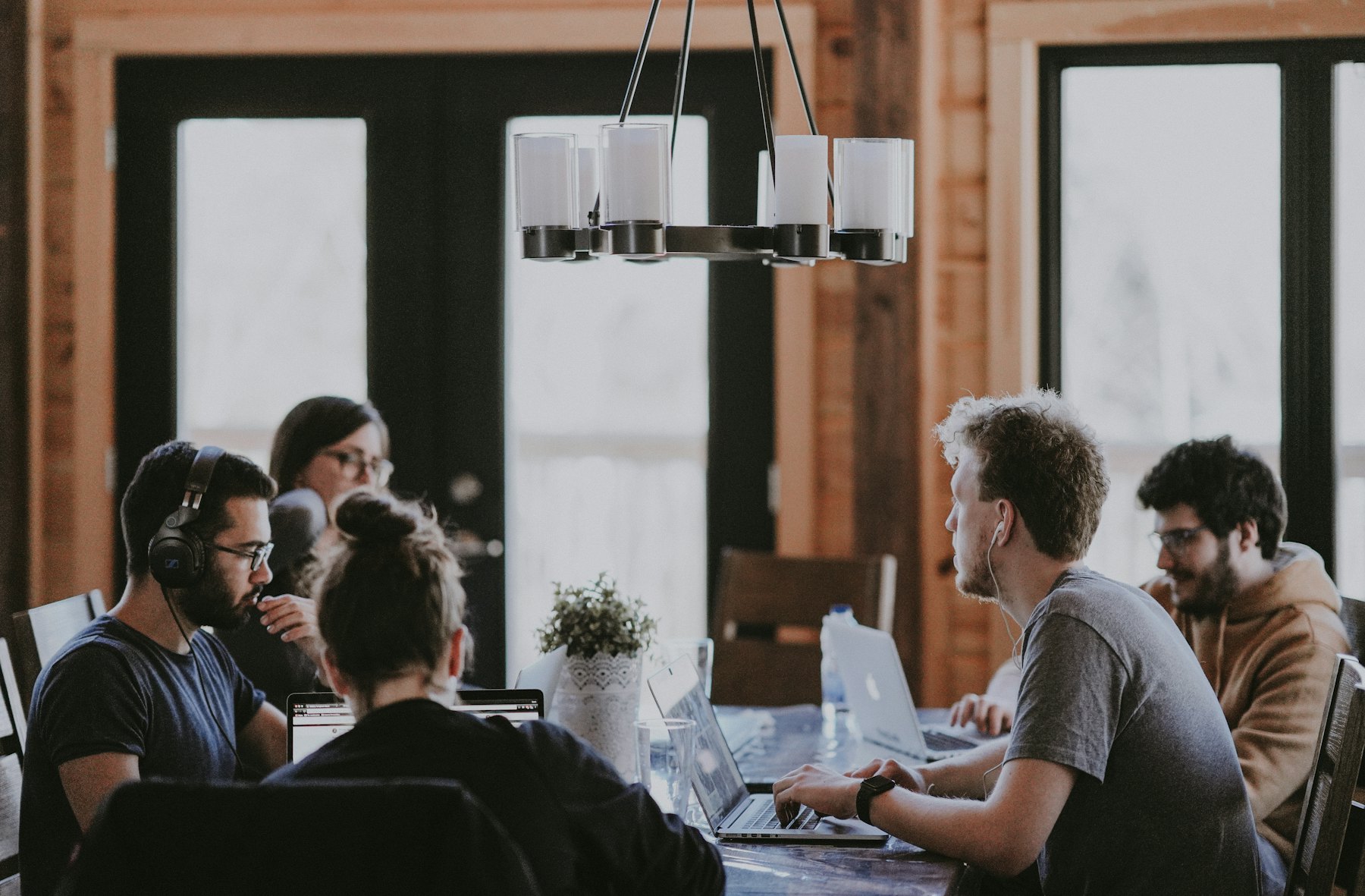 Small team meeting around a table in a warm-lit room