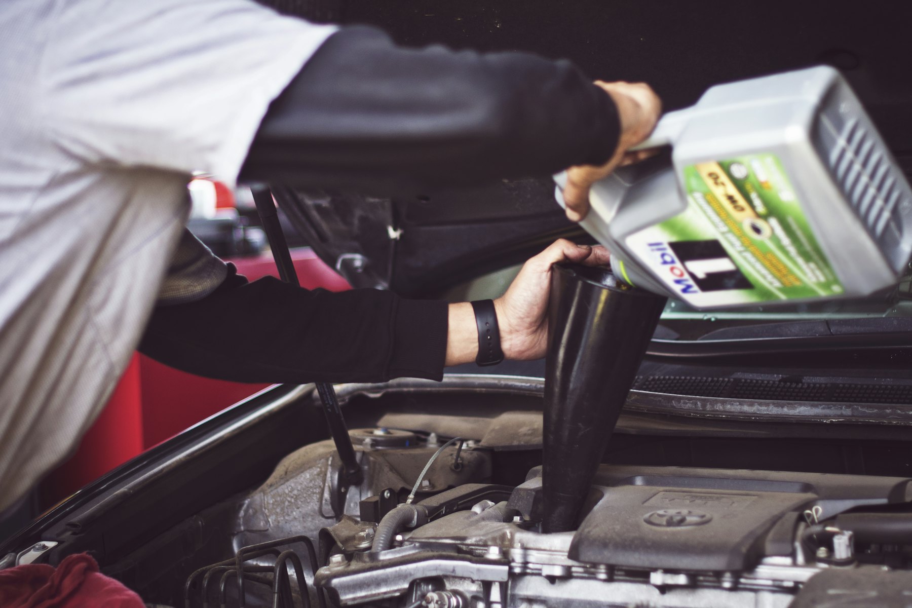 Mechanic working under the hood of a car